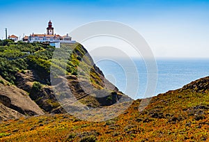 Stunning landscape with Cabo da Roca lighthouse overlooking the promontory towards the Atlantic Ocean, Portugal