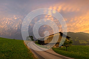 Stunning landscape image of a cottage along a country road in the mountains of Tyrol, Austria