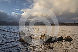 Stunning landscape image of Milarrochy Bay on Loch Lomond in Scottish Highlands with stunning Winter evening ligh