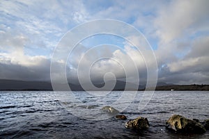 Stunning landscape image of Milarrochy Bay on Loch Lomond in Scottish Highlands with stunning Winter evening ligh