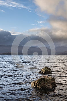 Stunning landscape image of Milarrochy Bay on Loch Lomond in Scottish Highlands with stunning Winter evening ligh