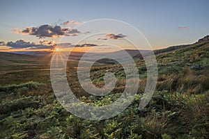 Stunning landscape image of Stanage Edge during Summer sunset in