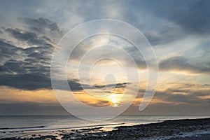 Stunning landscape image of white chalk cliffs with colorful vibrant sunset on English coast