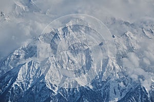 Stunning landscape of majestic snowy Hindu Kush mountain range and billowing white clouds