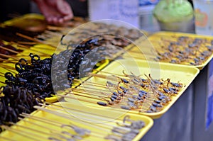 Stunning live scorpions are still alive as they are sold for food on small skewers near the Forbidden City, Beijing, , China