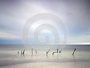 Stunning long exposure blur sunrise landsdcape of idyllic beach