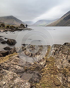 Stunning long exposure landscape image of Wast Water in UK Lake District during moody Spring evening