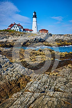 Stunning Maine white lighthouse on ocean along rocky coastline