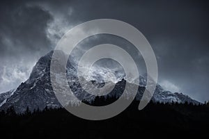 Stunning moody dramatic Winter landscape image of snowcapped Y Garn mountain in Snowdonia