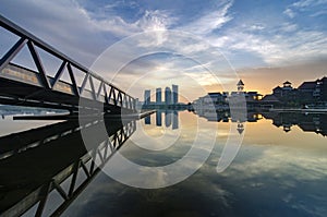 Stunning morning view near the lakeside, modern building and wooden jetty