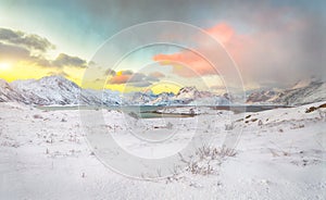 Stunning morning view of Torsfjorden fjord  and snowy mountain peaks at background during sunrise