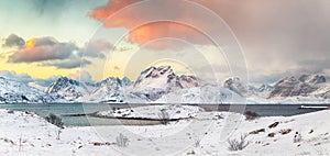 Stunning morning view of Torsfjorden fjord  and snowy mountain peaks at background during sunrise