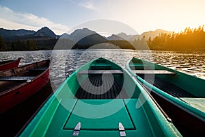 Stunning mountain lake with colorful wooden boat.