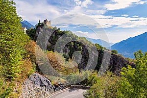 Stunning mountain landscape of a ruined castle next to a cliff