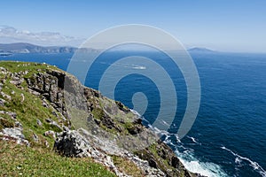 Stunning nature scene of Achill island, county Mayo, Ireland. Green hills and blue sky and ocean surface. Irish landscape. Warm