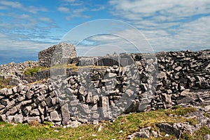 Stunning nature scenery of Aran island, county Galway, Ireland. Dry stone fences and blue cloudy sky. Warm sunny day. Irish nature