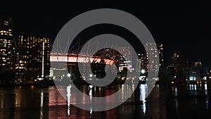 Stunning night view of False Creek bay at night in Vancouver downtown, Canada with lights of illuminated stadium.