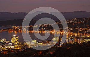 Stunning night view of Wellington, New Zealand, featuring the illuminated harbor.