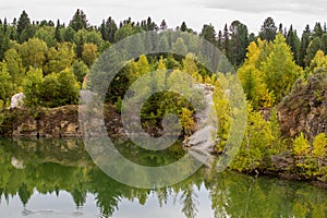 Stunning photo of fall foliage reflected on a lake with a glass like mirror water surface