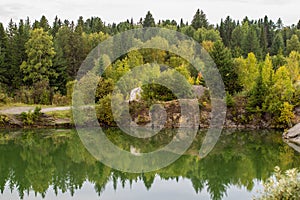 Stunning photo of fall foliage reflected on a lake with a glass like mirror water surface