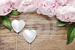 Stunning pink peonies on white rustic wooden background.