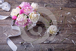 Stunning pink peonies on white rustic wooden background. Copy space