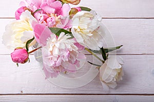 Stunning pink peonies on white rustic wooden background. Copy space