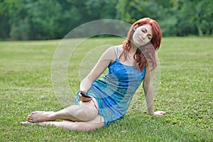 Stunning red haired woman outside - summer