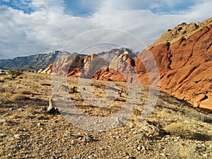 Stunning red orange desert mountains with cloudy blue sky