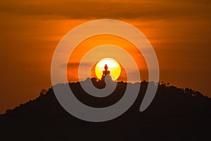 stunning red sky sunset the round sun is on the back of Phuket big Buddha