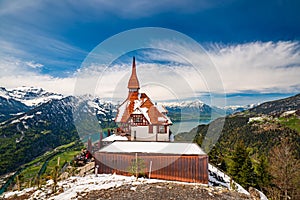 Stunning scenery with mountain hut on top Harder Kulm summit - popular tourist attraction over Interlaken, Switzerland