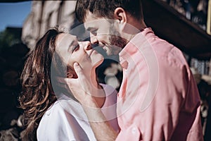 Stunning sensual outdoor portrait of young stylish fashion couple in love. Woman and man embrace and want to kiss each other