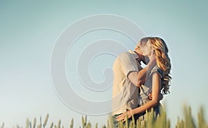 Stunning sensual young couple in love embracing at the sunset in