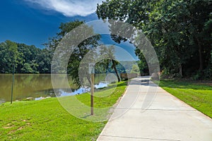 A stunning shot of a long  smooth winding footpath along side the silky brown waters on the Chattahoochee river