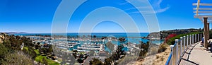 A stunning shot of the vast blue ocean water with white boats and yachts docked in the harbor and sailing in the harbor