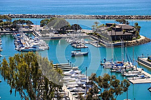 A stunning shot of the vast blue ocean water with white boats and yachts docked in the harbor and sailing in the harbor