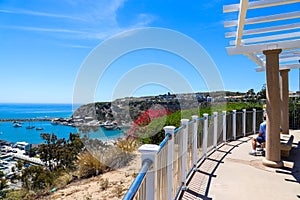 A stunning shot of the vast blue ocean water with white boats and yachts docked in the harbor and sailing in the harbor