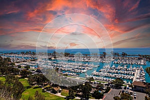 A stunning shot of the vast blue ocean water with white boats and yachts docked in the harbor and sailing in the harbor