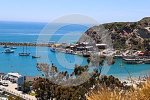 A stunning shot of the vast blue ocean water with white boats and yachts docked in the harbor and sailing in the harbor