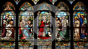 A stunning stained glass window in a church that depicts a religious scene or symbol. generative ai.
