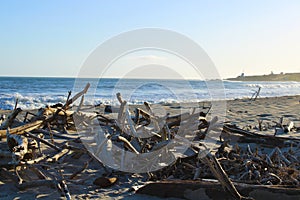 A stunning summer landscape at the beach at sunset with blue ocean water and waves rolling into the silky brown sands of the beach