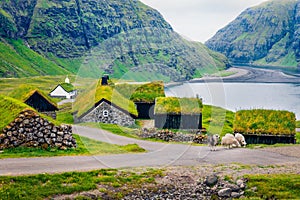 Stunning summer scene of Saksun village with typical turf-top houses and Saksunar Kirkja, Faroe Islands. Wonderful morning view of