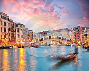 Stunning sunset and evening cityscape of Venice with famous Canal Grande and Rialto Bridge