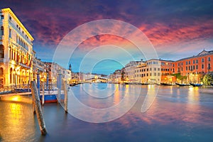 Stunning sunset and evening cityscape of Venice with famous Canal Grande and Rialto Bridge