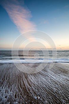 Stunning sunset over beach long exposure landscape