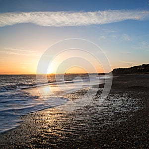 Stunning sunset over beach long exposure landscape