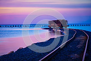 Stunning sunset over coastal railway and abandoned pier