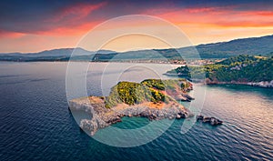 Stunning sunset on Saint Basil Beach with Agkali village on background, Nileas, Greece, Europe.