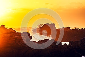 Stunning sunset shot of rocks and breaking waves at Cape Agulhas, South Africa`s and therefore Africa`s southernmost point