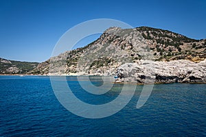 Stunning Tsambika Beach and Rock Formations of Rhodes Viewed from the Mediterranean Sea